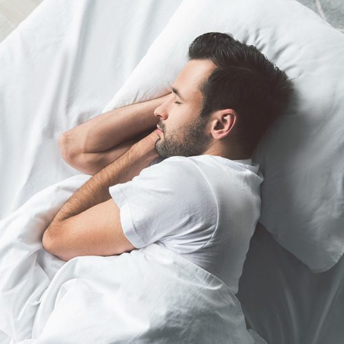 Man Asleep in Bed